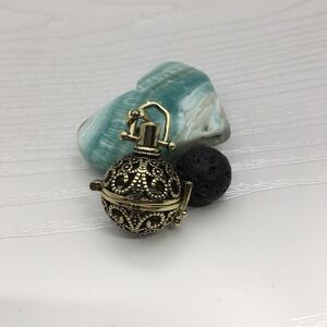 Pattern Aromatherapy Brass tone Locket.  Lava stone included.